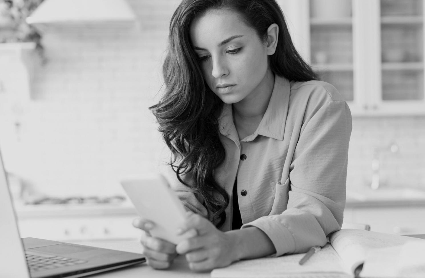 Professional analyzing complex financial data with multiple screens and reports